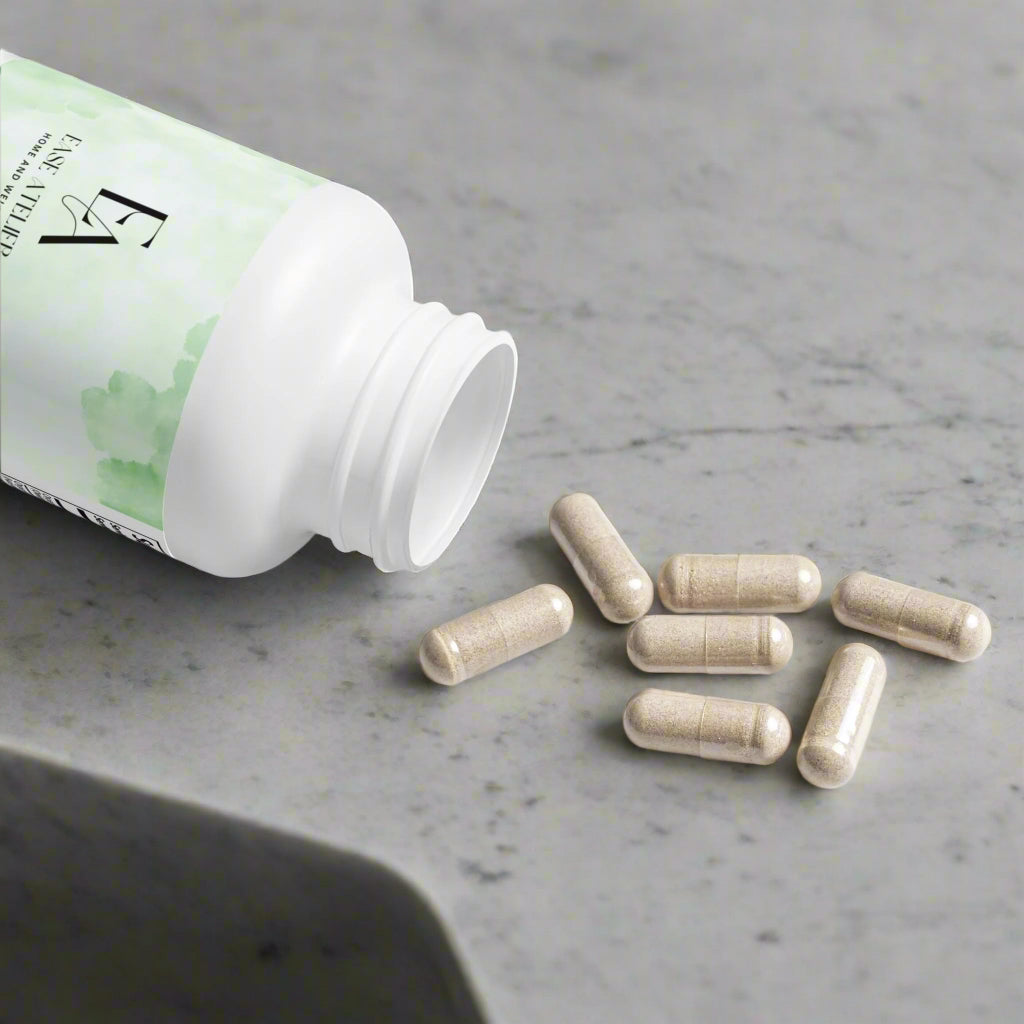White supplement bottle with green label and scattered capsules on a white background