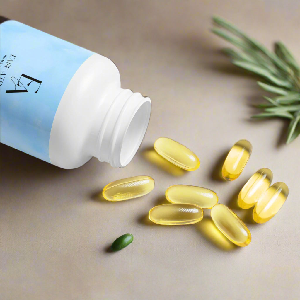 Yellow capsules spilling out of an open blue and white supplement bottle on a white background